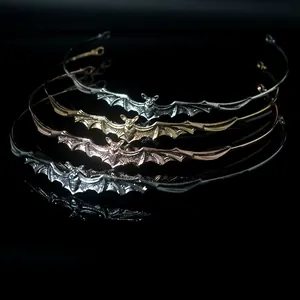 Detailed view of four Baroque bat alloy headbands in various metallic finishes
