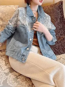 Stylish light blue denim jacket with heavy lace and sequin shoulder detailing on model