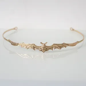 Close-up of gold gothic bat headband for Halloween party accessories