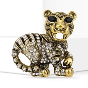 Detailed vintage tiger brooch crafted in gold-toned alloy with sparkling white rhinestones