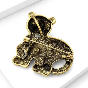 Detailed back view of a vintage gold-toned tiger brooch showing pin mechanism