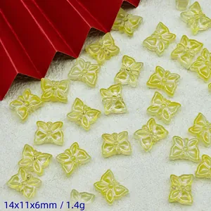 Macro detail of transparent yellow glass butterfly beads for handmade DIY jewelry
