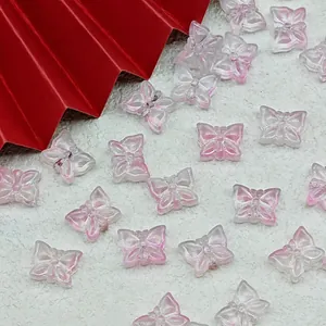 Close-up of translucent pink glass butterfly beads for handmade DIY jewelry crafting