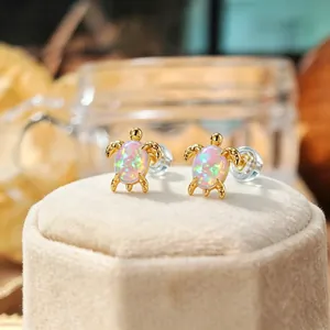 Ocean series sea turtle stud earrings with iridescent pink synthetic opal in gold finish