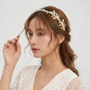 Elegant golden leaf headband with pearls and rhinestones on a model's hair