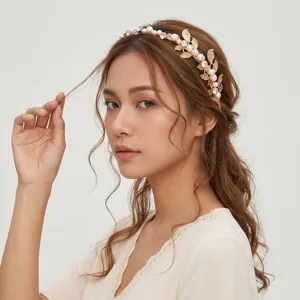 Elegant gold bridal headband with fine pearls, rhinestones and delicate leaf designs