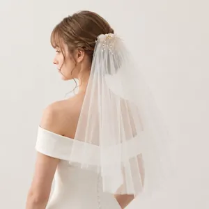 Elegant double-layered bridal veil featuring a delicate pearl flower hair comb detail