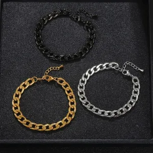 Detail of stainless steel Cuban link bracelets in black, gold, and silver finishes