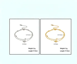Detail view of gold and silver double-layer bracelets with laser-cut four-leaf clover charm