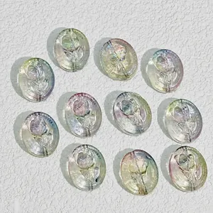 Macro view of 18x15mm iridescent oval glass beads with embossed rose pattern for DIY.