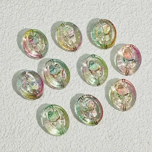 Close-up of 18x15mm iridescent oval glass beads with rose design for DIY crafts