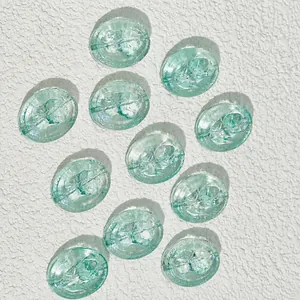 Detail of 18x15mm oval light blue glass beads with intricate rose floral pattern