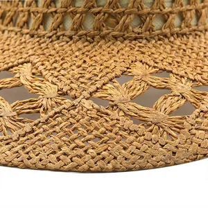 Detailed macro view showing the intricate hollow woven pattern on natural straw hat
