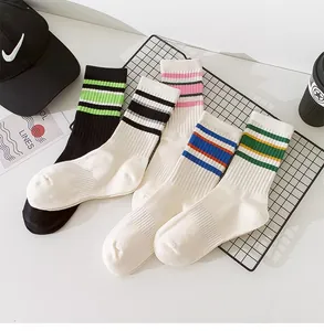 Set of stylish striped mid-calf sports socks in various colors displayed on a wire rack