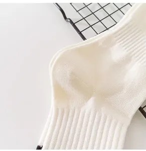 Detail of cream white ribbed mid-calf socks with soft cotton texture