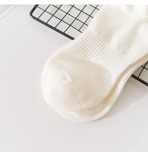 Detailed close-up view of white ribbed crew sports socks highlighting toe seam and fabric texture