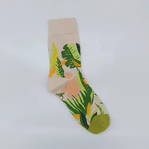 Detailed close-up showing the vibrant tropical monstera leaf jacquard pattern on cotton socks