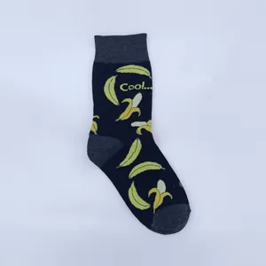 Close-up of a dark navy mid-calf sock with vibrant yellow banana patterns and Cool text.