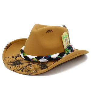 Close-up of tan cowboy hat featuring floral printed brim and ethnic braided band.
