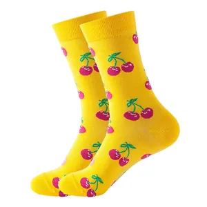 Macro detail of vibrant yellow crew socks featuring a cute pink cherry pattern print.
