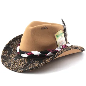 Detail of a brown felt cowboy hat featuring a decorative feather and vintage-style tag