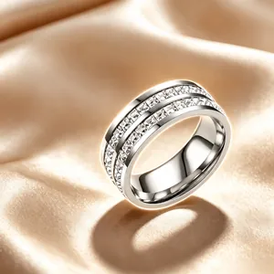 Detailed view of a silver stainless steel ring with double rows of square crystals
