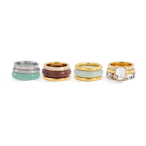 Set of four stacked natural stone and stainless steel rings with clear crystal details