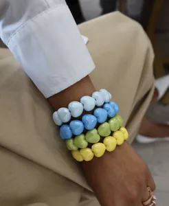 Close-up detail of colorful heart-shaped beaded bracelets in vibrant candy colors