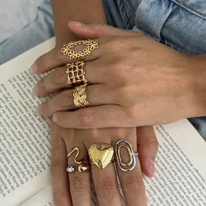 Macro view of vintage-style stainless steel rings with floral and heart motifs