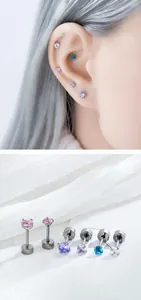 Detail of mini four-prong zircon stud earrings for cartilage piercing in titanium steel.