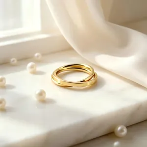 Macro view of interlocking gold stainless steel double ring on elegant marble background