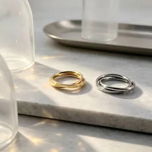 Aesthetic shot of minimalist interlocking stainless steel rings in gold and silver