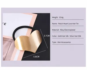 Detailed view of the large gold brushed metal heart hair tie showing size and weight specs
