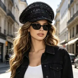Stylish woman wearing a black rhinestone-encrusted punk style navy hat in an urban street