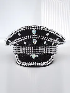 Detail of punk style black military hat with silver spikes and iridescent rhinestones
