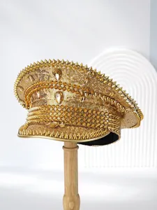Detailed view of a gold punk style navy hat with sequins and cone studs