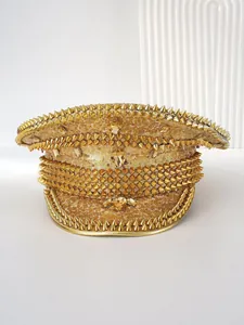 Detail of a gold sequin military hat with rhinestones and punk style spikes