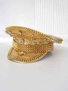Detailed macro view of high-fashion gold sequined captain hat with punk style cone studs