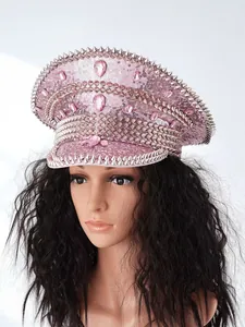 Close-up detail of a pink rhinestone-encrusted captain hat with punk style silver spikes