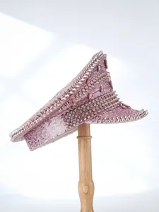 Detailed view of pink sequin captain hat featuring dense metallic studs in punk y2k style