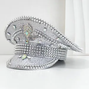 Silver sequin military hat with punk spikes and iridescent gemstones detail view