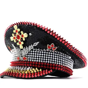 Detailed macro shot of punk Y2K captain hat with red studs and crystal cross.