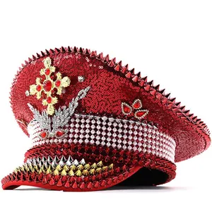 Detailed macro view of red sequin punk military hat featuring spikes and rhinestone cross