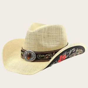 Detalle de sombrero de vaquero de paja con bordado floral y banda con piedra preciosa