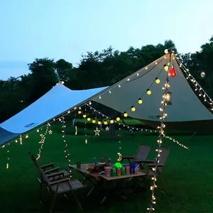 Cozy camping setup with G50 globe LED string lights hanging under a tent canopy.