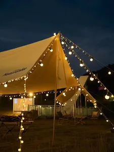 Atmospheric warm G50 LED globe string lights decorating a camping canopy at night
