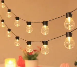 Warm glowing G50 LED bulb string lights for festive decoration and cozy camping vibes.