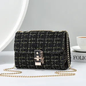 Elegant black tweed shoulder bag with gold chain strap and stylish flip-lock closure