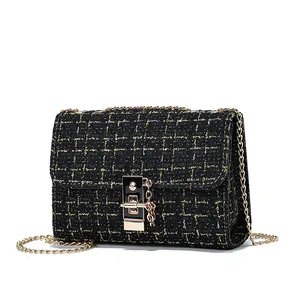 Elegant black and gold tweed chain crossbody bag with luxury metal lock for women