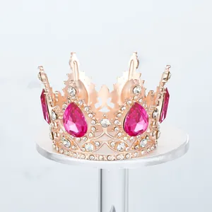 Primer plano de una corona de oro rosa con pedrería rosa para decoración de pasteles